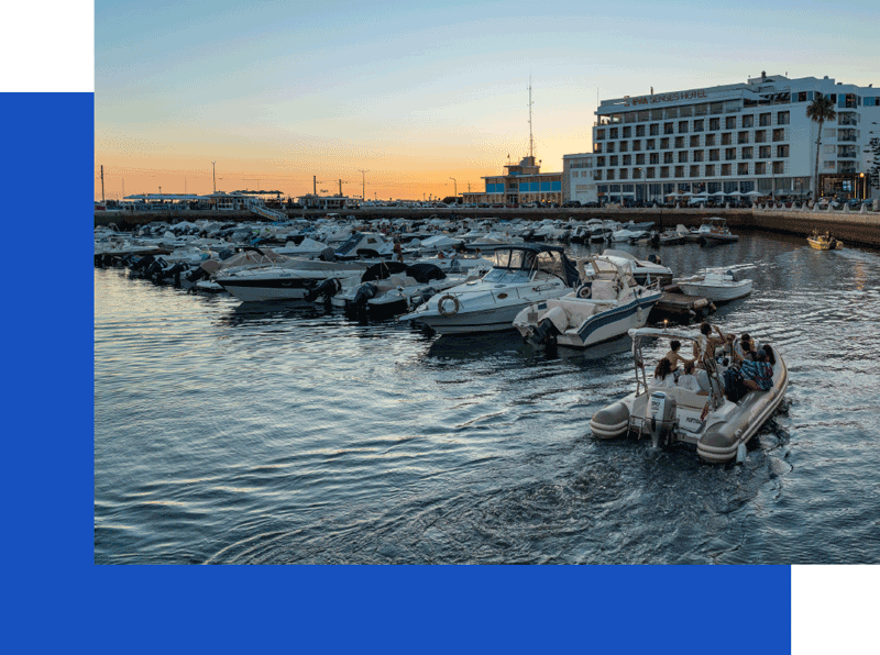 Boats in marina at sunset in Faro