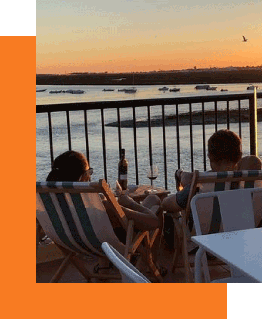 Couple watching sunset by the lake.