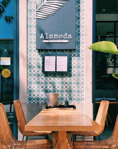 Street café with decorative tiled wall in Faro