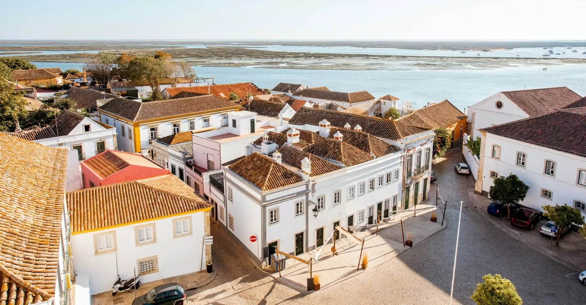 Aerial view of coastal town with white buildings.