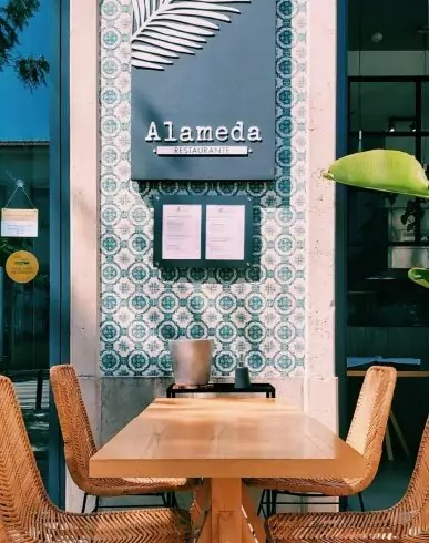 Street café with decorative tiled wall in Faro