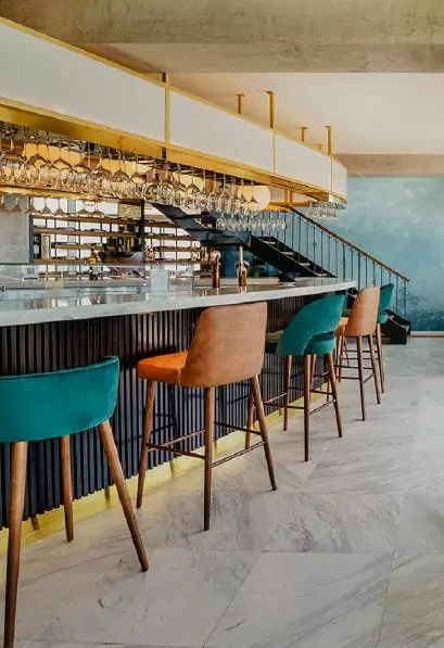 Modern bar with colorful stools and glasses