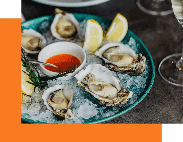 Plate of oysters with lemon and sauce