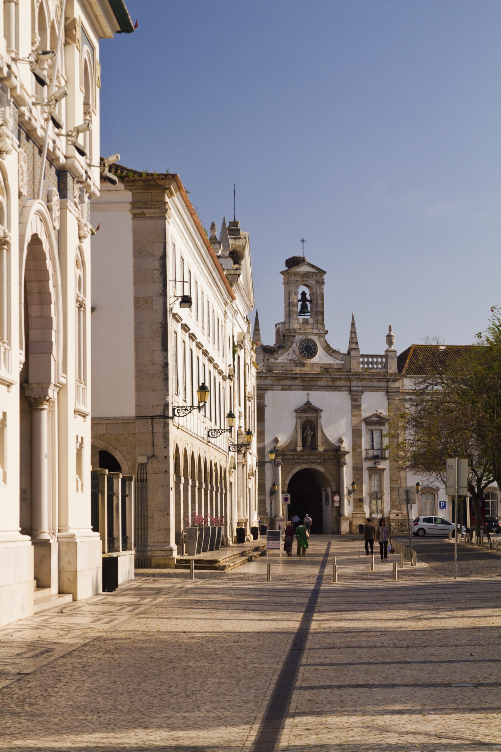 Arc of the Vila Historic church in Faro, Portugal under clear sky.