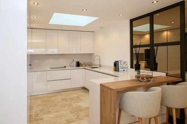 Modern white kitchen with wooden breakfast bar