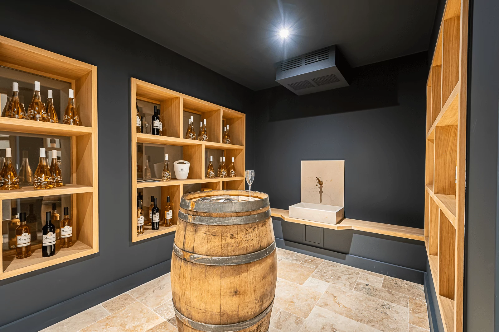 Modern wine cellar with wooden shelves and barrel