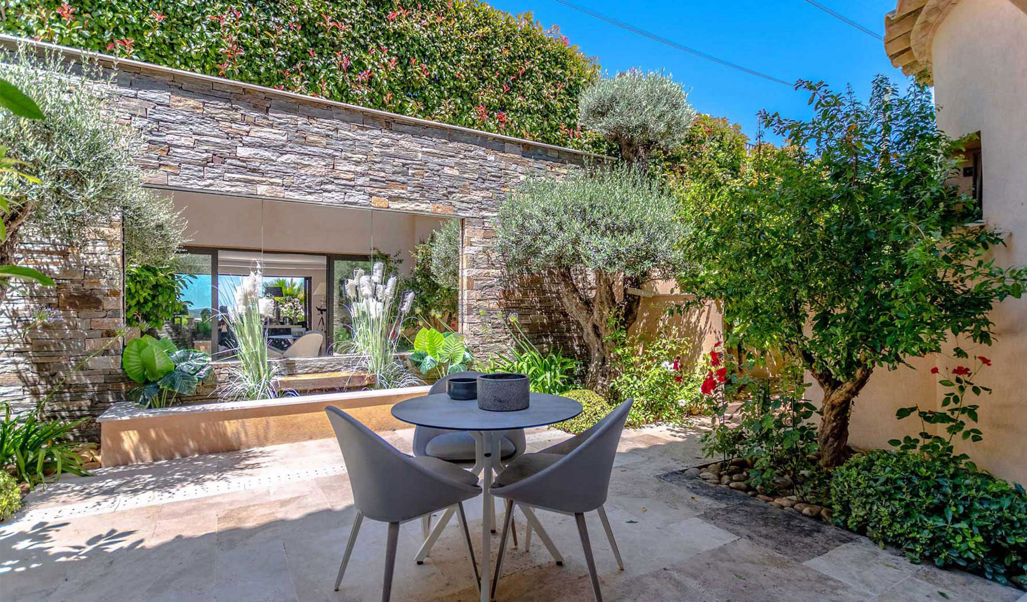 Outdoor patio with table and chairs lush garden