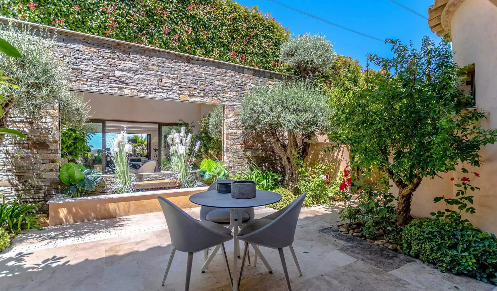 Outdoor patio with table and chairs lush garden